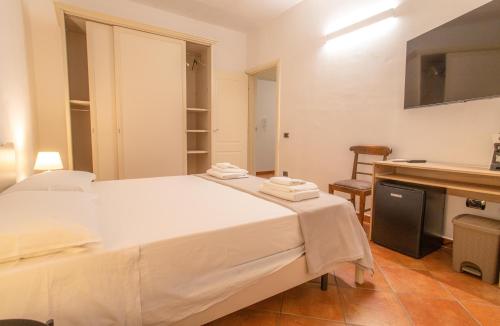 Ένα ή περισσότερα κρεβάτια σε δωμάτιο στο Porto Vecchio Rooms
