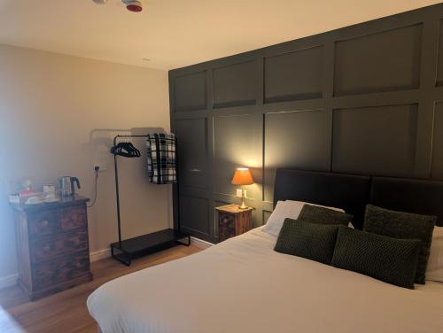 a bedroom with a large bed with a large headboard at The Castle Inn hotel 