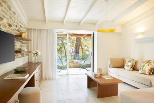 a living room with a couch and a table at Makryammos in Limenas