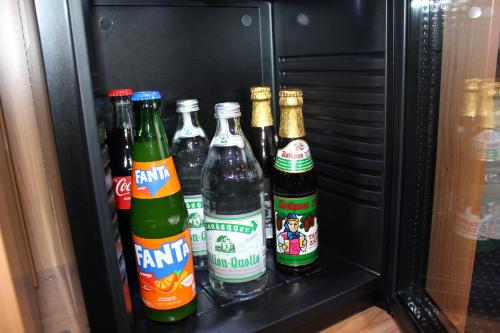 a refrigerator filled with different types of beer bottles at Hotel Capri in Überlingen