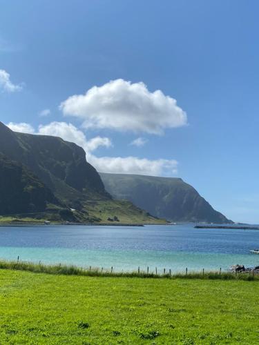 a view of a lake with mountains in the background at Honey bay cottage in Stadlandet