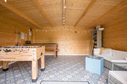 a room with a ping pong table in a room at The Farmhouse Boundary Farm Framlingham in Woodbridge