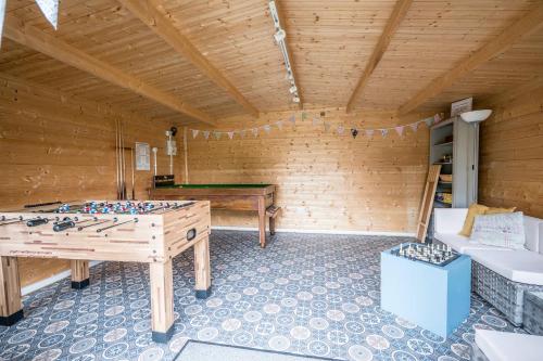 a room with a ping pong table in a room at The Farmhouse Boundary Farm Framlingham in Woodbridge