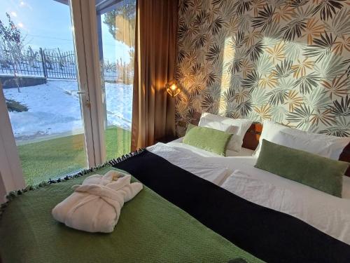 a bedroom with a bed with a towel on it at Welcome House Eger in Eger