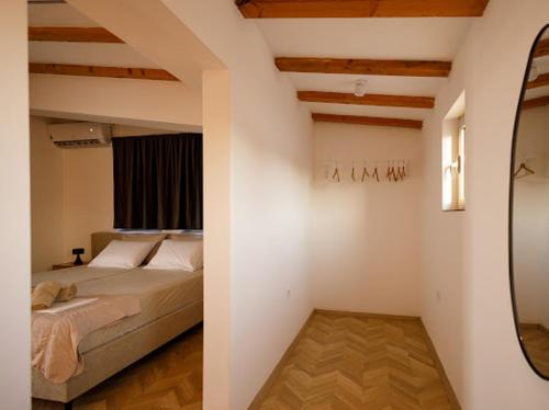 a bedroom with a bed and a mirror in it at Velvet Apartments in Strumica