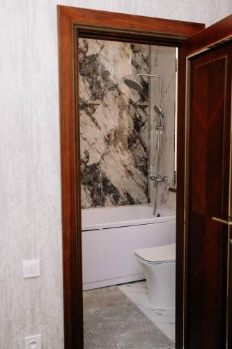 un bagno con vasca, WC e lavandino di Maksima Hotel a Samarkand