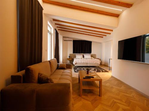 a living room with a couch and a tv at Velvet Apartments in Strumica