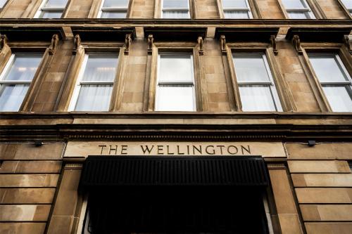 a building with a sign that reads the wellington at The Wellington Glasgow by Adina in Glasgow
