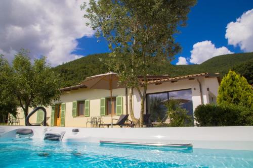 a house with a swimming pool in front of a house at Agriturismo La Cascina di Opaco in Norcia
