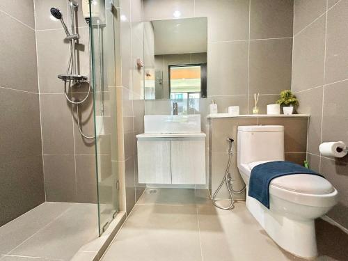 a bathroom with a toilet and a sink and a shower at 1 Bedroom Condos Close to Shopping Malls in Ban Rangeng