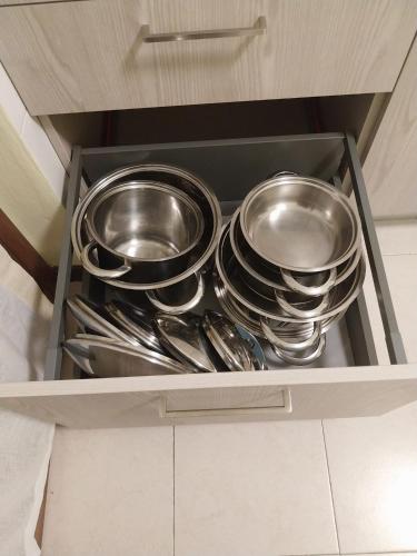 a drawer filled with silver dishes and utensils at Appartamento Castore in Terno d'Isola