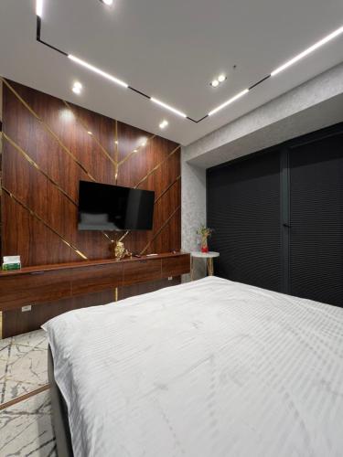 a bedroom with a bed and a flat screen tv at TuranWay Apart 1 NRG U Tower in Tashkent