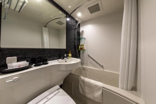 a bathroom with a sink and a toilet and a shower at Kobe Plaza Hotel in Kobe