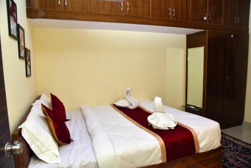 a bedroom with a bed with two animals on it at Tech Park Residency Manyata in Bengaluru