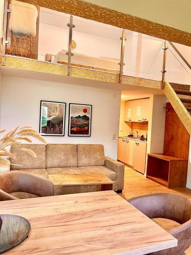 a living room with a couch and a table at Allgäuer Ferienwohnung mit Schwimmbad- und Sauna-Zugang in Wiggensbach