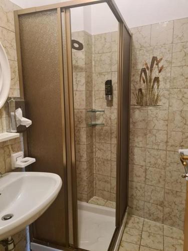 a bathroom with a shower with a sink and a toilet at Hotel Tirol- Natural Idyll in Montesover