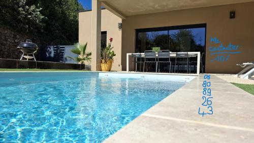 a swimming pool in front of a house at Maison des libellules de dugradus in Aubenas