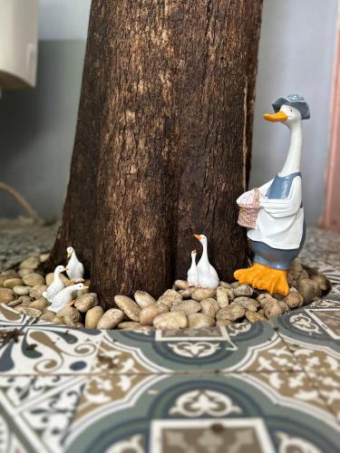 a group of toy ducks standing next to a tree at Nunou Cafe in Ban Than Lao