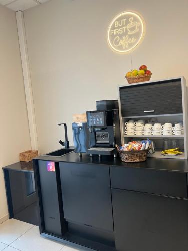 a counter in a coffee shop with a coffee maker at Hotel Capri in Überlingen