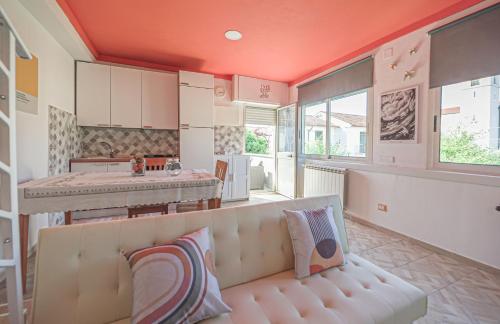 a living room with a couch and a kitchen at Il Campanile B&B in Roccasecca