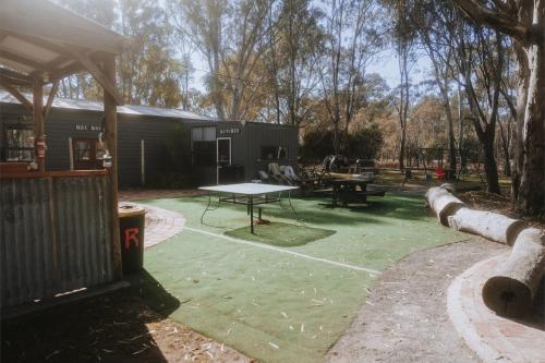 a backyard with a ping pong table and a tent at Tiny Homes Escape at Grampians Edge by Tiny Away in Dadswells Bridge