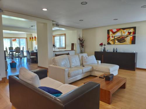 a living room with two couches and a table at 2 Floors Villa Close Apulia Beach in Esposende