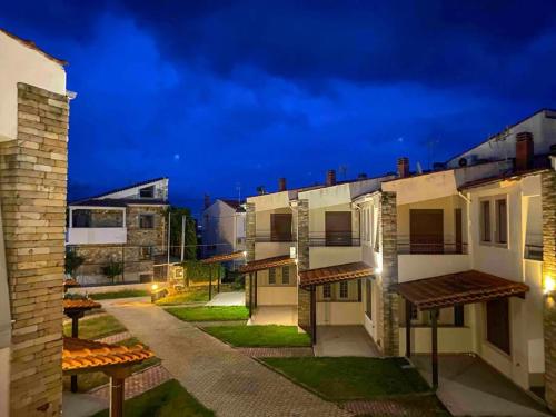 a row of apartment buildings at night at Andreadis maissonette in Skala Potamias