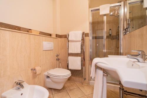 a bathroom with a toilet and a sink at Verdeluna ApartHotel in Marina di Pietrasanta