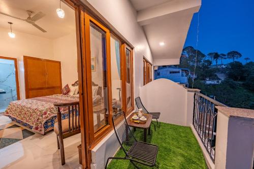 a room with a balcony with a bed and a table at Hotel Sun Ray Inn in Bhowāli