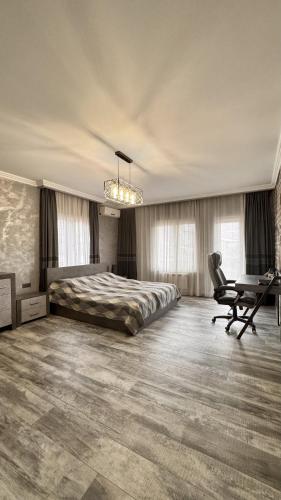 a bedroom with a bed and a desk and a chair at The Yerevan Residence in Yerevan