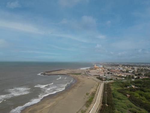 an aerial view of a beach and the ocean at Clarks Collection Somnath in Somnath
