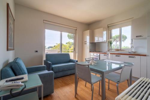 a living room with a table and a couch at Verdeluna ApartHotel in Marina di Pietrasanta