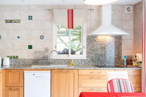 a kitchen with a sink and a window at Gure Xokoa in Urrugne