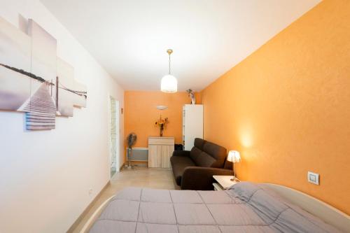a living room with a bed and a couch at Gure Xokoa in Urrugne