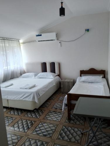 a room with two beds and a table in it at New Wave1 in Grigoleti