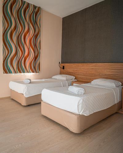 Ένα ή περισσότερα κρεβάτια σε δωμάτιο στο Yucesan Hotel
