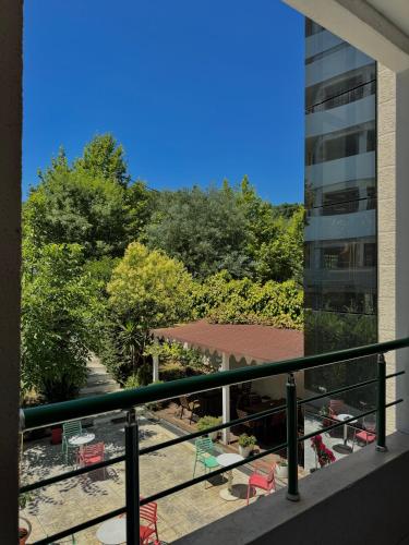 a balcony with a view of a patio and a building at Vila Park Hotel 1 in Tirana