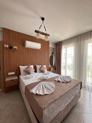 a bedroom with a large bed in a room at Yaz Villa 2 in Fethiye