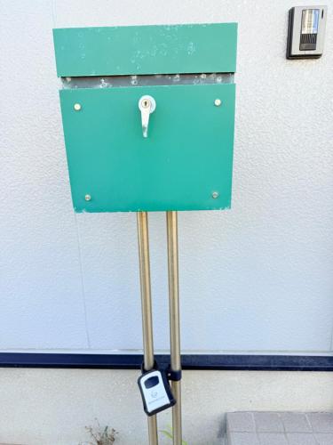 a blue box with a key in front of a door at 西戸崎3丁目8番1号 in Fukuoka