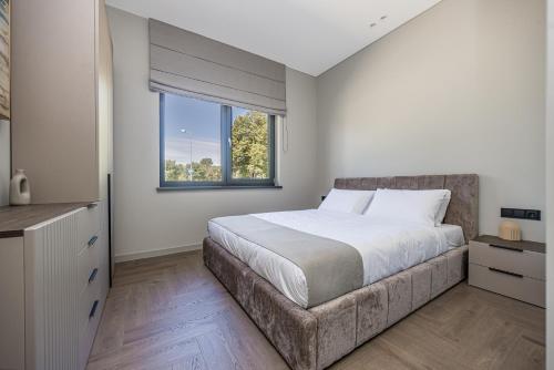 a bedroom with a large bed and a window at Baltijos parkas - Šventoji in Šventoji