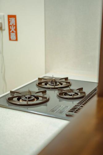 a stove top with four burners on top of it at 箱根 森の風を感じる一軒家 in Hakone