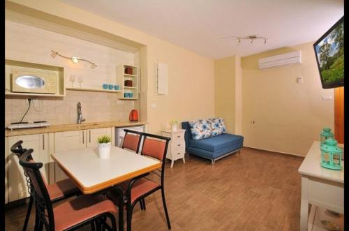 a kitchen and living room with a table and a couch at מול כנרת בליבנים in Livnim