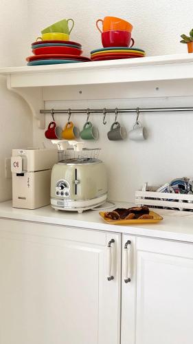 a kitchen counter with a toaster on a shelf at Palazzo Ammicc in Bernalda