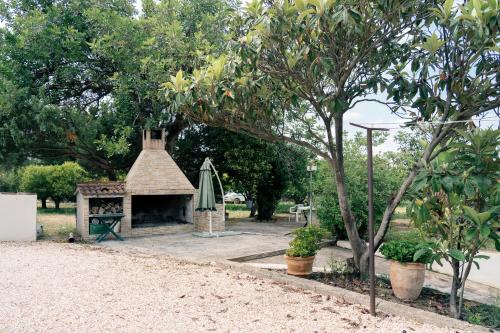 a picnic shelter in a park next to a tree at Casa Matilde in Orosei