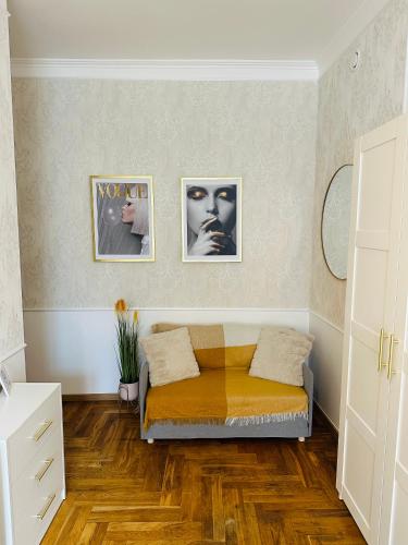 a bedroom with a bed and two pictures on the wall at Happy8 in Gdynia