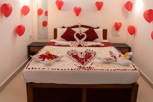 a bedroom with a bed with hearts on the wall at Sonikas Leisure in Candolim