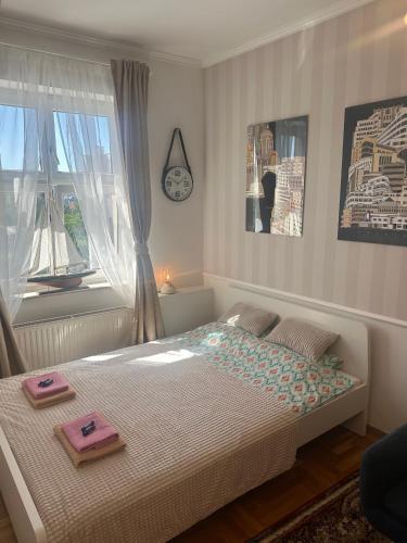 a bedroom with a bed with two towels on it at Happy8 in Gdynia