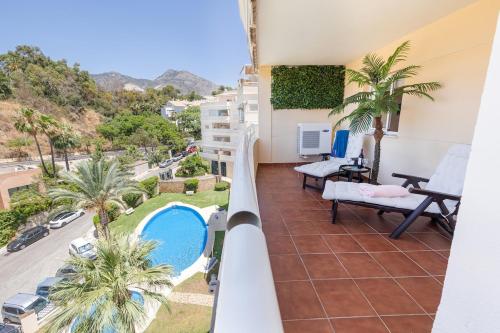 a view from the balcony of a apartment with a swimming pool at Chill & Shine - Sun and Relax in Benalmádena