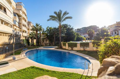 a swimming pool in a yard next to a building at Chill & Shine - Sun and Relax in Benalmádena