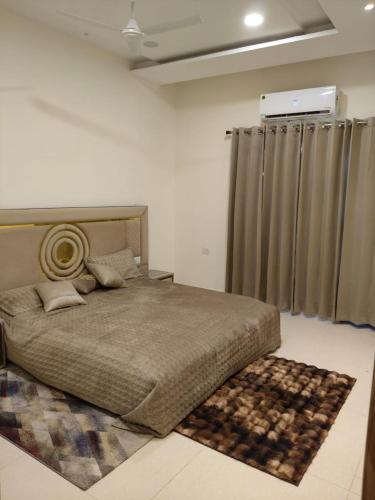 a bedroom with a large bed with a rug at Park Avenue in Ludhiana